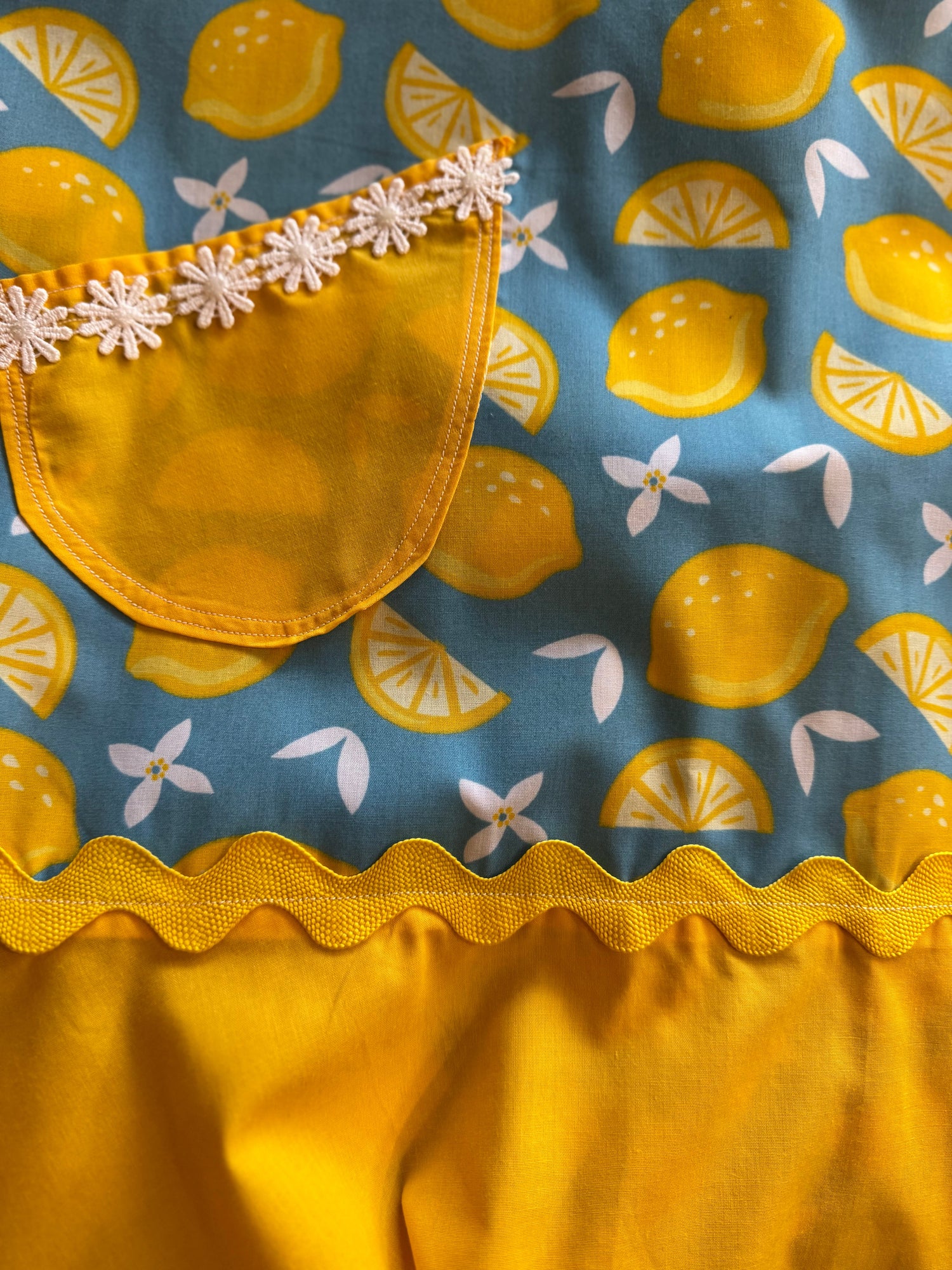 Adult apron made with a fun lemon print fabric and trimmed with yellow rick rack