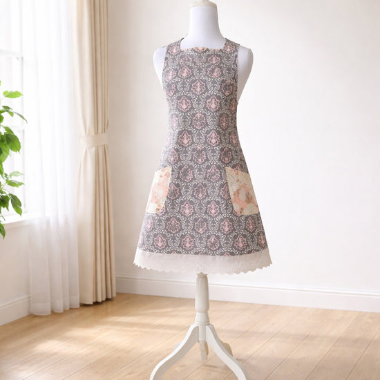 Adult apron made from grey and pink fabric with cream accents
